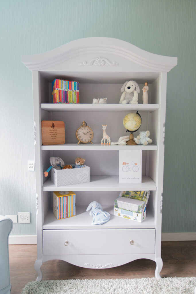 Auriga Bookshelf styled in a soft pastel nursery for Baby Moodley, showcasing toys, books, and keepsakes