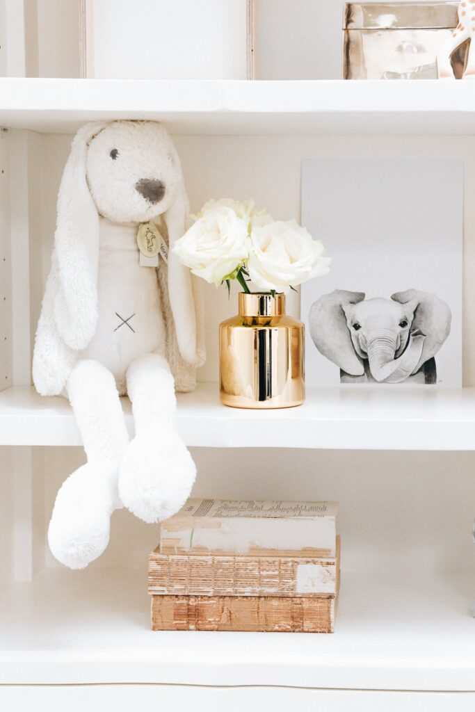 Close-up of the Isabella Bookshelf styled with plush toys and décor in Jenna McArthur's nursery