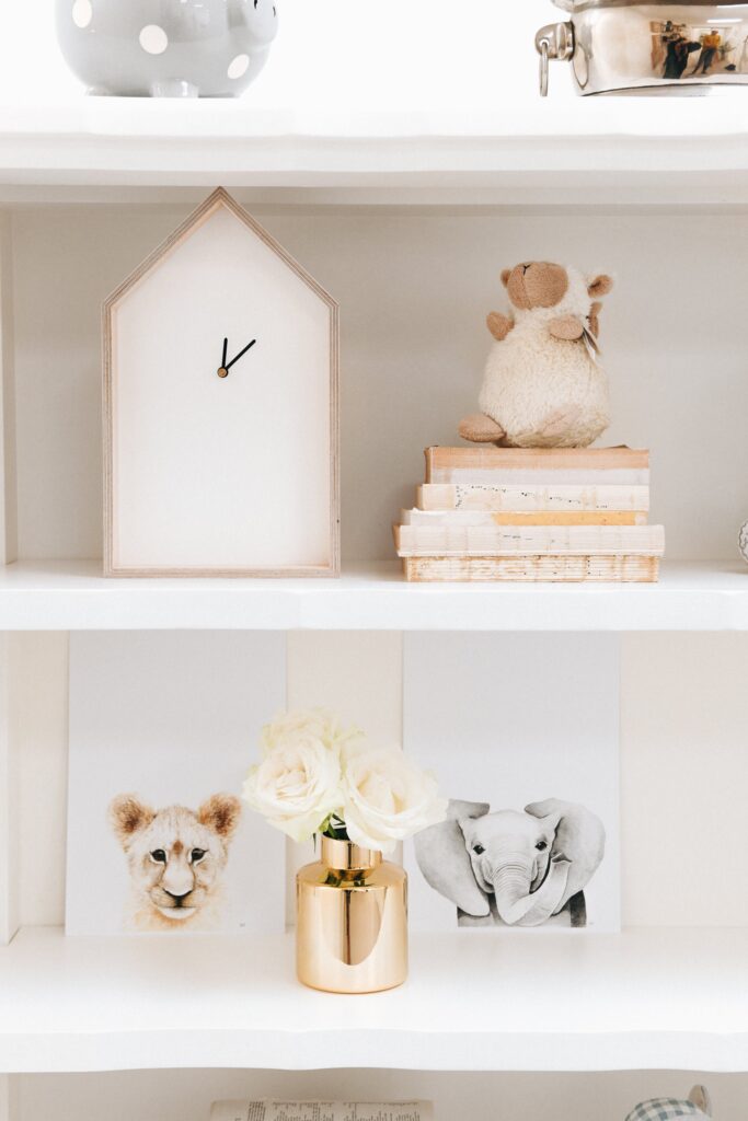 Close-up of the Isabella Bookshelf styled with soft toys, vintage books, and art prints in Jenna McArthur’s nursery